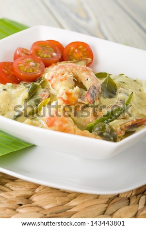 Prawn Molee - Keralan prawn curry with coconut milk turmeric and curry leaves garnished with tomatoes.