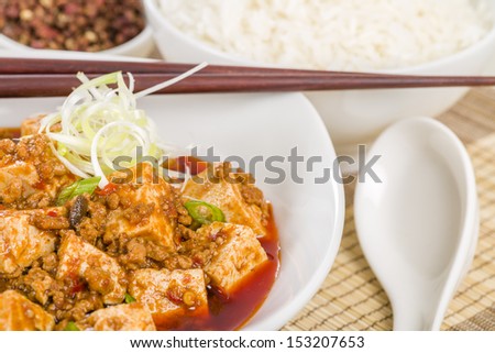 Mapo Tofu - Tofu and minced pork cooked with chili bean paste, fermented black beans, chili oil and Szechuan peppers, garnished with spring onions. Served with white steamed rice.