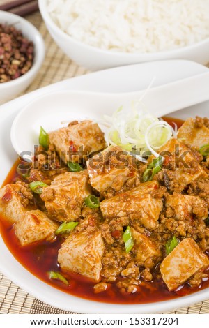 Mapo Tofu - Tofu and minced pork cooked with chili bean paste, fermented black beans, chili oil and Szechuan peppers, garnished with spring onions. Served with white steamed rice.