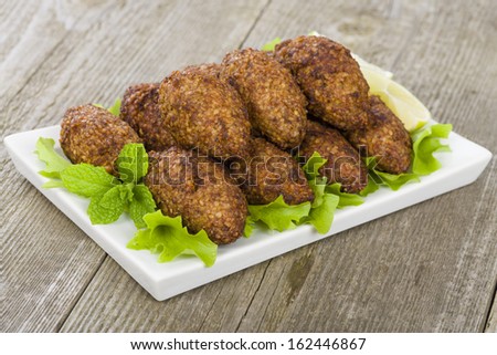 Kibbeh - Middle Eastern minced meat and bulghur wheat fried snack. Also popular party dish in Brazil (kibe).