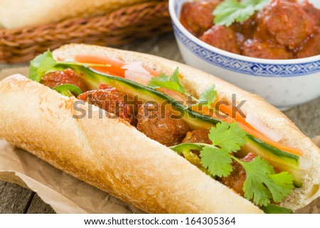 Banh Mi Xiu Mai - Vietnamese sandwich with meatballs in tomato sauce, do chua (radish and carrot pickle), cucumber and coriander.