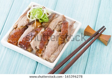 Peking Duck - Chinese roast crispy duck on a blue background.