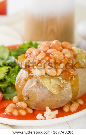 Jacket Potato - Baked potato topped with cheese and served with salad and baked beans