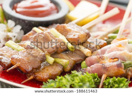 Kushiyaki - Butabara (belly pork) and Asuparabekon (asparagus wrapped in bacon). Japanese grilled food on skewers.