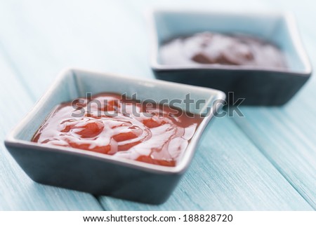 Dips - Chili and BBQ sauce on a blue background.