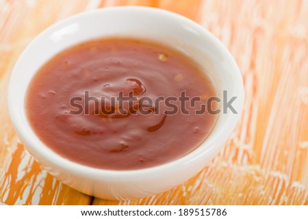 Sweet Chili Sauce - Asian style sweet chili sauce on a crackled orange background.