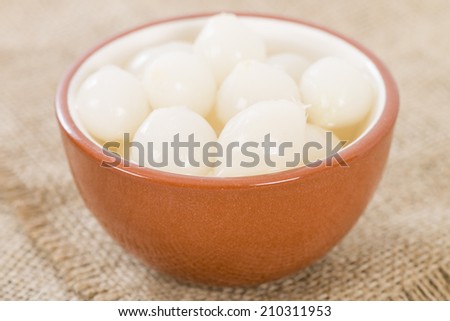 Silverskin Pickled Onions - Small onions pickled with vinegar and salt in a bowl.