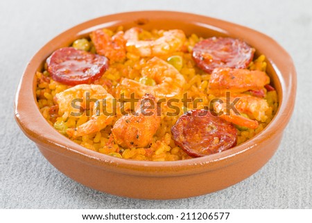 Mixed Paella - Individual portion of mixed paella with chicken, chorizo and prawns in a cazuela.