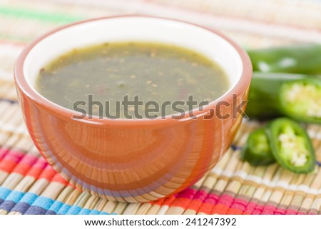Jalapeno Relish - Bowl of jalapeno sauce on a colourful background.