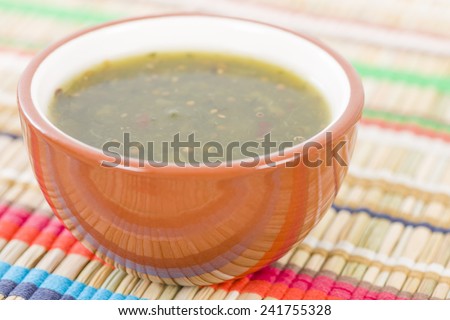 Jalapeno Relish - Bowl of jalapeno sauce on a colourful background.