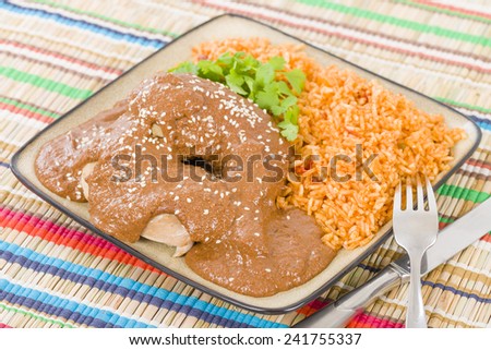 Mole Poblano - Chicken with mole sauce and tomato rice. Traditional Mexican food.