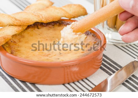 Baked Cheese - Melted cheese dip served with breadsticks.