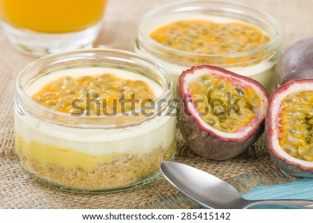 Passion Fruit Cheesecake - Individual potted dessert made with passion fruit whipped cream and a biscuit base, topped with passion fruit pulp.
