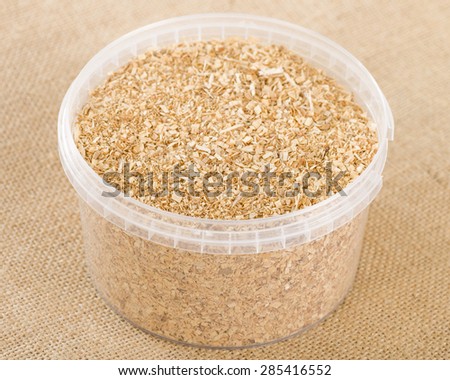 Hickory Wood Chips - Finely ground hickory wood chips used for smoking in a plastic round container.