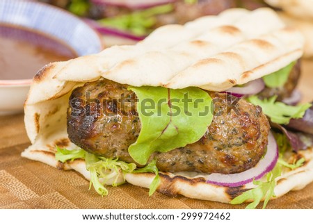 Lamb Kebabs in Flatbread - Minted minced lamb kebabs in  flatbreads with salad and sauces.