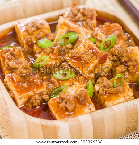 Mapo Tofu - Tofu and minced pork cooked with chili bean paste, fermented black beans, chili oil and Szechuan peppers, garnished with spring onions.