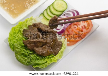 Cambodian (Loc Lac) / Vietnamese (Bo Luc Lac) stir-fried beef salad - Shaking Beef. Served with a lime and black pepper dip.