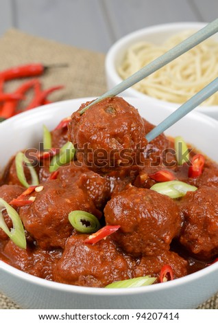 Xiu Mai - Vietnamese spicy pork meatballs in fragrant tomato sauce served with noodles.