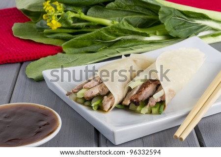 Peking Duck - Chinese peking duck wrapped in pancakes with cucumber, spring onions and hoisin sauce