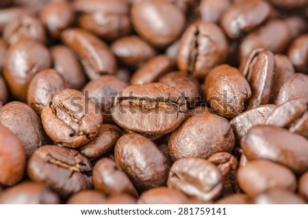 Close up of roasted coffee beans, selected focus on center coffee bean