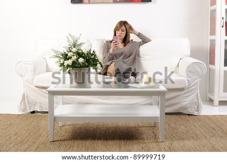 Girl in her living room chatting on the phone