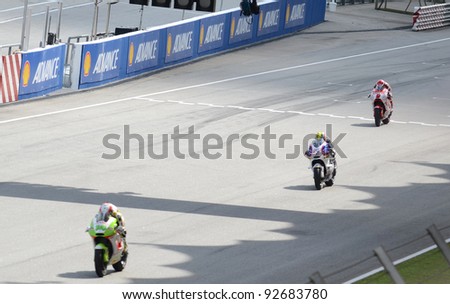 SEPANG, MALAYSIA - OCT. 21: Three MotoGP riders in action during a practice session of the Shell Advance Malaysian Moto GrandPrix on Oct. 21, 2011 in Sepang, Malaysia.