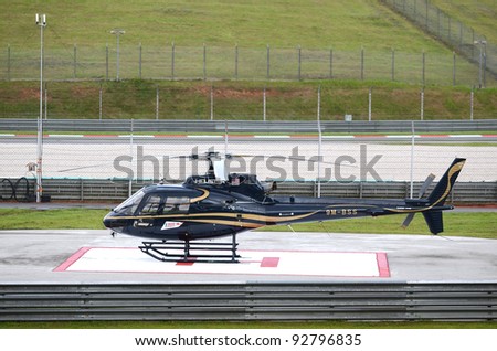 SEPANG, MALAYSIA-OCT.21: A black helicopter in parking standby during practice session of Shell Advance Malaysian Moto GrandPrix on Oct. 21 2011 in Sepang, Malaysia.