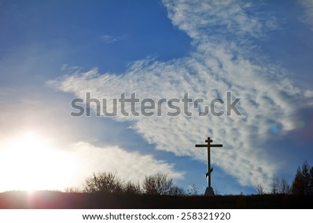 Christian cross on a hill against the sky symbol of faith