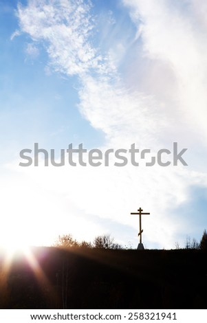 Christian cross on a hill against the sky symbol of faith