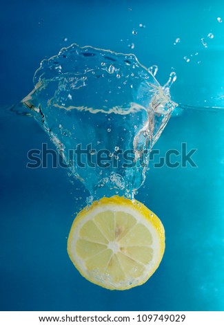 Lemon splashing into cold water