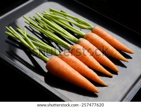 fresh carrots on a black background