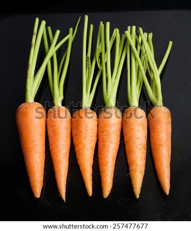 fresh carrots on a black background