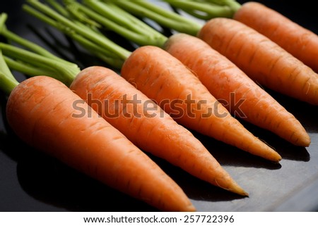 Fresh carrots on a black background