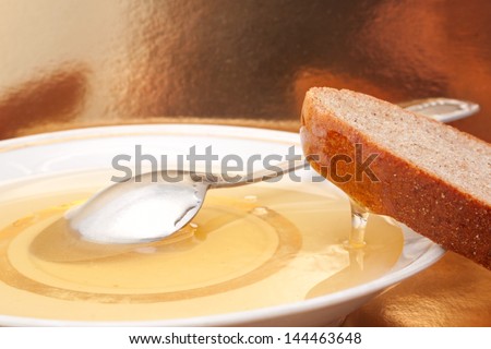 The still life with the natural honey and slice of brown bread