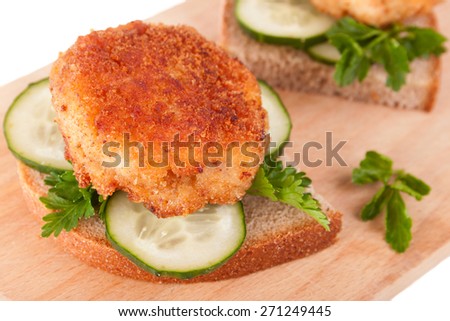 Sandwiches with Yummy Cutlet, Bread, Cucumber and Parsley on the Kitchen Board