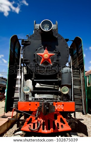 blck steam locomotive on a background of blue sky