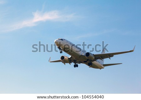white plane with the gear against the blue sky