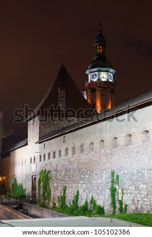 Defensive walls and tower of the Bernardine monastery in Lviv, in the light of lanterns at night