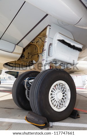 rear landing gear and jet engine passenger plane on the ground