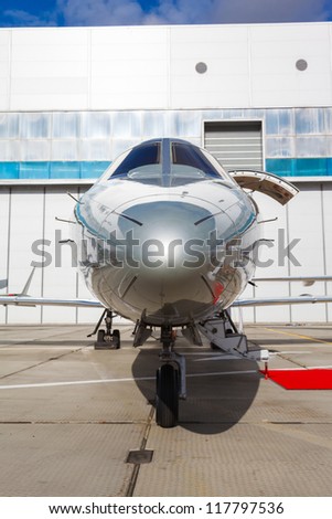 silver reactive private jet, the front landing gear and  gangways