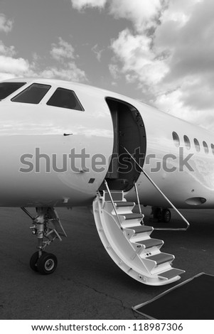 ladder in a private jet and red carpet on ground