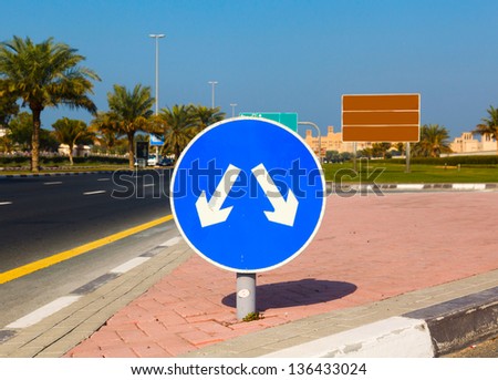 Road sign with opposite arrows