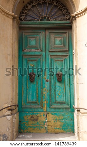 green wooden front door to the house in the Mediterranean