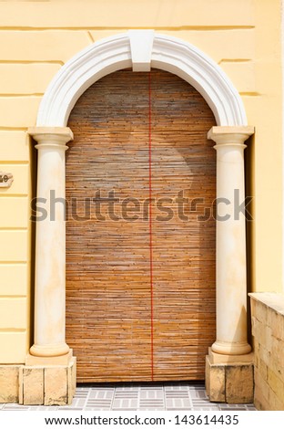 curtain of reeds and columns at the entrance to the Maltese House