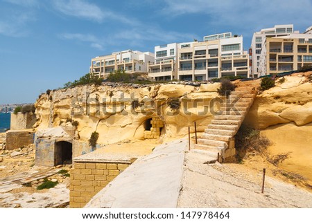 ancient stairs in the Fort Tigne (Sliema) fortress (Sliema, Maltese islands) and new apartment buildings 2013