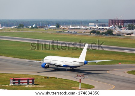 white plane takes off from the runway on the background of houses
