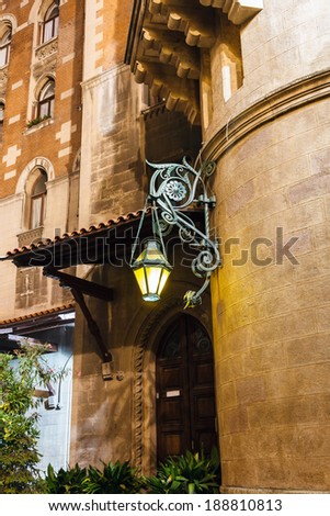 Old forged lantern at night on the background wall with bas relief in Istanbul, Turkey