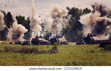 German medium half-track armored personnel on the field in the smoke and explosions of shells