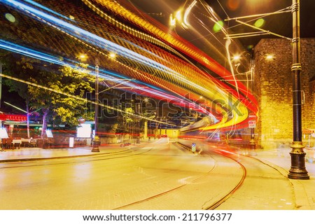 public transport metropolis, traffic and blurry lights tram at night, Istanbul, Turkey