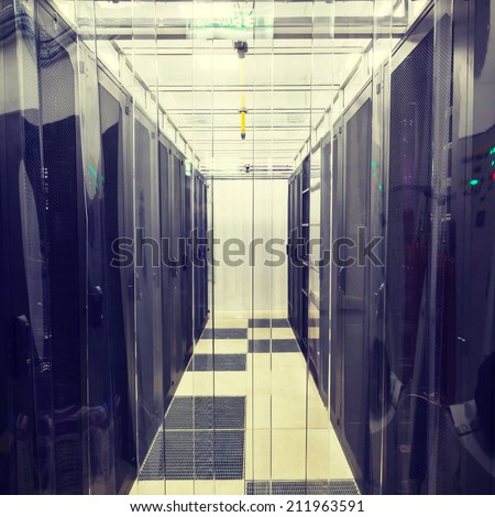 racks in the data center in the cold aisle through the transparent curtains